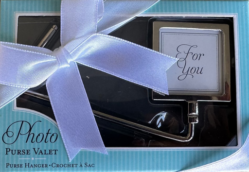 Photo purse valet with a blue box and white ribbon on a textured surface